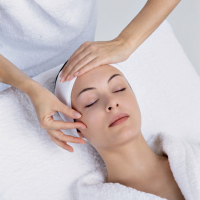 A woman receiving a professional skincare facial treatment